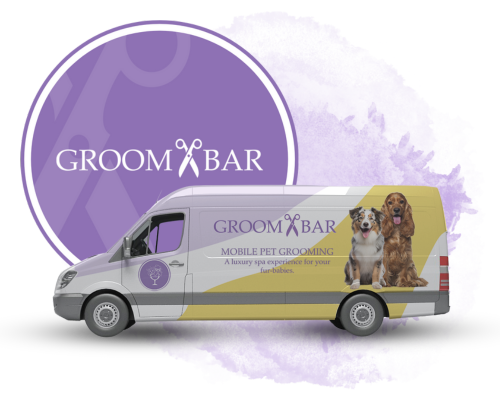 A picture of a mobile grooming van with the groombar logo on the side and a groombar logo that is sitting behind the van